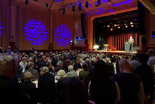 [Translate to Französisch:] Une salle pleine avec un orateur.